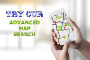 Hand holding mobile phone with map and text Try Our Advanced Map Search